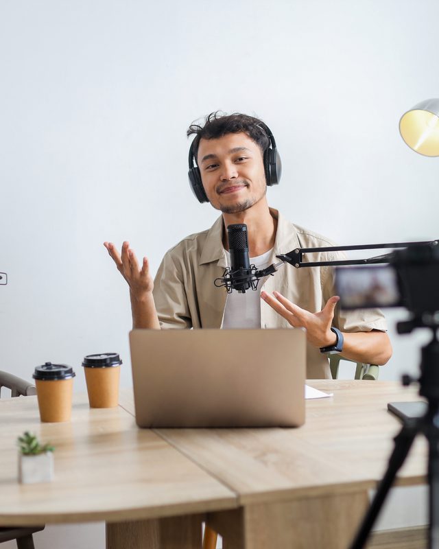 Host recording a video podcast episode in a multicam studio setup